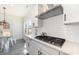Well-lit kitchen area with modern appliances, countertops, white cabinets, and tiled backsplash at 7019 Lenton Rd, Charlotte, NC 28215