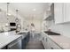 Gourmet kitchen with a view of living area, features modern appliances and a sleek design at 7019 Lenton Rd, Charlotte, NC 28215