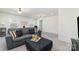 Spacious living area with gray sofa, ottoman, and pillows with ample natural light at 7019 Lenton Rd, Charlotte, NC 28215