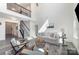 Spacious living room featuring high ceilings, modern decor, a cozy seating area, and staircase access at 7019 Lenton Rd, Charlotte, NC 28215