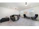 Spacious bonus room with neutral walls, carpet, a gray sofa and a comfortable seating area at 7019 Lenton Rd, Charlotte, NC 28215