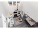 Open-concept floor plan with a fireplace, vaulted ceilings, fan, and living and dining areas with natural light at 7019 Lenton Rd, Charlotte, NC 28215