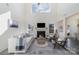 Bright, open living room with high ceilings, modern decor, a fireplace, and large windows for ample natural light at 7019 Lenton Rd, Charlotte, NC 28215