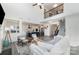 Open-concept living space with modern kitchen, living room, staircase, and abundant natural light at 7019 Lenton Rd, Charlotte, NC 28215