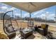 Covered porch with comfortable egg chairs and a ceiling fan, perfect for relaxation at 7019 Lenton Rd, Charlotte, NC 28215