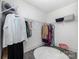 Spacious walk-in closet featuring wire shelving for optimal organization, plus a furry rug and pink stool at 7019 Lenton Rd, Charlotte, NC 28215