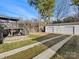View of a backyard with a deck, a large garage with three bays, and a long driveway at 7314 Entwhistle Ct, Charlotte, NC 28226