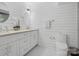 Bright, white bathroom featuring shiplap walls, a modern vanity, round mirror and a toilet at 7314 Entwhistle Ct, Charlotte, NC 28226