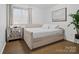Cozy bedroom featuring hardwood floors, a daybed, natural light, and simple decor at 7314 Entwhistle Ct, Charlotte, NC 28226