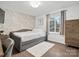 Stylish bedroom featuring geometric wallpaper, hardwood floors, and a modern bed at 7314 Entwhistle Ct, Charlotte, NC 28226