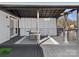 Outdoor deck featuring patio seating, curtains, a heat lamp and wooded views at 7314 Entwhistle Ct, Charlotte, NC 28226