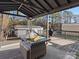 Inviting outdoor deck with patio furniture, a heat lamp, grill and a backyard view at 7314 Entwhistle Ct, Charlotte, NC 28226