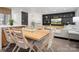Inviting dining area with a wooden table, seating for six, and views into the stylish living room at 7314 Entwhistle Ct, Charlotte, NC 28226