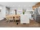 Modern kitchen and dining area boasting white cabinets, stainless steel appliances, and a quartz-topped island at 7314 Entwhistle Ct, Charlotte, NC 28226