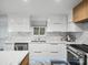 Bright kitchen showcases white cabinets, stainless steel appliances, and elegant marble countertops at 7314 Entwhistle Ct, Charlotte, NC 28226