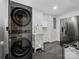 Modern laundry room with gray washer and dryer, a utility sink, and a stainless steel refrigerator at 7314 Entwhistle Ct, Charlotte, NC 28226