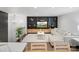 Inviting living room with custom built-in shelving, a comfortable sectional, and an open staircase nearby at 7314 Entwhistle Ct, Charlotte, NC 28226