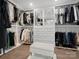 Bright, organized walk-in closet with custom shelving, drawers, and stylish display areas for clothing and shoes at 7314 Entwhistle Ct, Charlotte, NC 28226