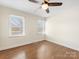 Bedroom features a ceiling fan and natural light from two sunny windows at 7440 Apple Creek Dr, Mint Hill, NC 28227