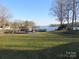 Lakefront backyard with a lush lawn leading to a private dock and beautiful water views at 8188 Normandy Rd, Denver, NC 28037