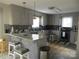 Well-lit kitchen with granite counters and gray cabinetry and backsplash at 8188 Normandy Rd, Denver, NC 28037