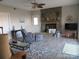 Inviting living room features a stone fireplace, wood flooring, and comfortable seating at 8188 Normandy Rd, Denver, NC 28037