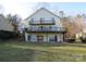 Rear exterior featuring multiple decks and outdoor seating offering panoramic lake views at 8188 Normandy Rd, Denver, NC 28037