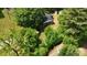 Aerial view of a secluded home surrounded by mature trees and greenery at 833 E Chestnut St, Stanley, NC 28164