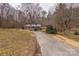 Ranch house with driveway and wooded setting at 833 E Chestnut St, Stanley, NC 28164