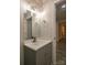 Bathroom vanity with modern lighting and fixtures, a gray base cabinet, and neutral paint at 833 E Chestnut St, Stanley, NC 28164