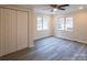 Bedroom features wood-look flooring, a ceiling fan, and double windows providing natural light at 833 E Chestnut St, Stanley, NC 28164