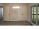 Dining area with wood-look flooring, a chandelier, and sliding glass door to the porch at 833 E Chestnut St, Stanley, NC 28164