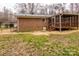 Exterior view of a brick home with a screened-in porch addition and a metal roof at 833 E Chestnut St, Stanley, NC 28164