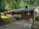Traditional brick home with a metal roof and front yard at 833 E Chestnut St, Stanley, NC 28164