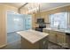 Modern kitchen with island, stainless steel appliances, and view to dining area at 833 E Chestnut St, Stanley, NC 28164