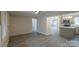 Bright living area with access to the kitchen and a screened in porch at 833 E Chestnut St, Stanley, NC 28164