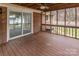 Outdoor patio with wood ceiling, fan, screen railing, and sliding door to the house at 833 E Chestnut St, Stanley, NC 28164