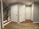 Finished basement features multiple doors, wood stairs and laminate flooring at 11724 Blessington Rd, Huntersville, NC 28978