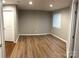 Finished basement features wood-look flooring and a light-filled window at 11724 Blessington Rd, Huntersville, NC 28978