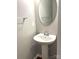 Powder room featuring a pedestal sink, oval mirror, and hardwood floors at 11724 Blessington Rd, Huntersville, NC 28978