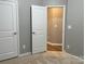Neutral bedroom features two white doors and an open closet, offering plenty of space at 11724 Blessington Rd, Huntersville, NC 28978