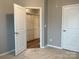Neutral bedroom features a closet and a white door, offering plenty of space at 11724 Blessington Rd, Huntersville, NC 28978