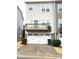 A townhome featuring a two car garage with carriage door hardware and an elevated back deck at 11724 Blessington Rd, Huntersville, NC 28978