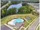 Aerial view of the neighborhood pool, clubhouse, and tennis courts with lake nearby at 119 Winterberry St, Mooresville, NC 28117