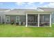 Well-maintained backyard featuring a screened-in patio perfect for outdoor entertainment at 119 Winterberry St, Mooresville, NC 28117
