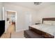 Bright bedroom with neutral walls and a wooden bed frame with cushioned bench at the foot of the bed at 119 Winterberry St, Mooresville, NC 28117