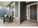 Inviting front porch with comfortable seating and tasteful landscaping, creating a warm welcome at 119 Winterberry St, Mooresville, NC 28117