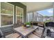 This screened-in patio has a table and chairs for outside enjoyment and entertaining at 119 Winterberry St, Mooresville, NC 28117