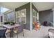An inviting screened-in patio features a dining table and chairs, ideal for outdoor meals at 119 Winterberry St, Mooresville, NC 28117