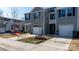 Well-maintained townhome featuring gray siding, stone accents, attached garages, and a manicured lawn at 1475 Cypress Loop # 29, Newton, NC 28658